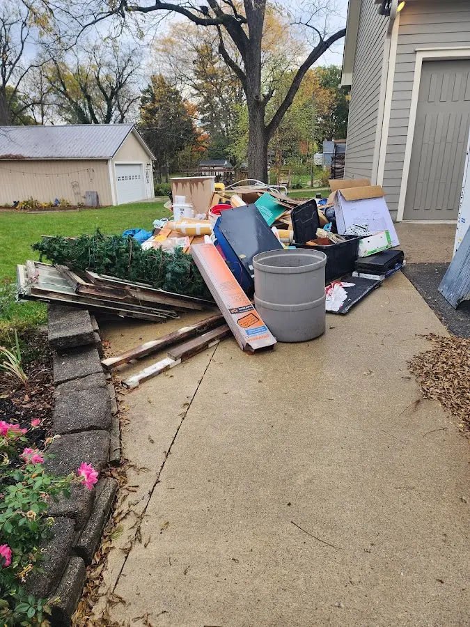 Dumpster being loaded with debris for 12 Yard Dumpster Rental in Martinsville
